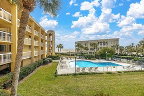 A hotel with a swimming pool, multiple balconies, and a view of the beach. - Stunning views overlooking the Atlantic Ocean (Saint Simons Island)