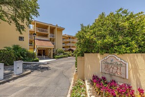 A multi-story building with a sign reading 'King and Prince Beach Villas South.'
