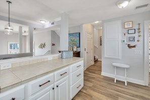 Modern kitchen with a large island, oven, and pendant light.