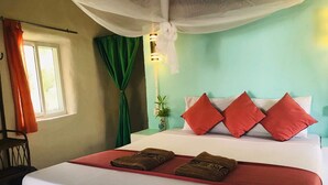 A bed with red and white bedding, a green curtain, and a white canopy. - Bohemiaz Resort and Spa (Kampot)