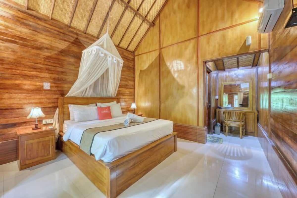 A wooden room with a bed, bedside table, and a canopy bed.