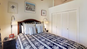 A bedroom with a large bed, two bedside lamps, a nightstand, a framed picture, and a closet. - Elegant Creekside Condo with Scenic Views & Pool with Access to Grand Hyatt (Vail)