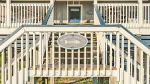 A wooden deck with a sign that reads "NO BONES ABOUT IT" and "Built 1979". - Panoramic views from the wrap around porch overlooking south bald head (Bald Head Island)
