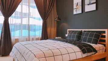 Cozy bedroom with a large bed, wooden headboard, and framed artworks.