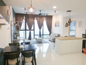 A modern kitchen with a dining area, large windows with curtains, and a view of the city. - South Key Mosaic (Johor Bahru)
