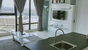 A modern kitchen with a large window, a flat-screen TV, and a sink. - South Key Mosaic (Johor Bahru)