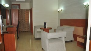 A hotel room with a bed, a desk, a chair, and a TV. - Top Rank Hotel (Abuja)