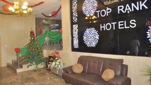 A reception area with a sign reading "Welcome to TOP RANK HOTELS". - Top Rank Hotel (Abuja)