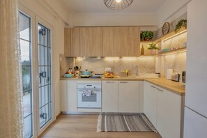 A modern kitchen with wooden cabinets, a built-in oven, and a countertop with various kitchen items.