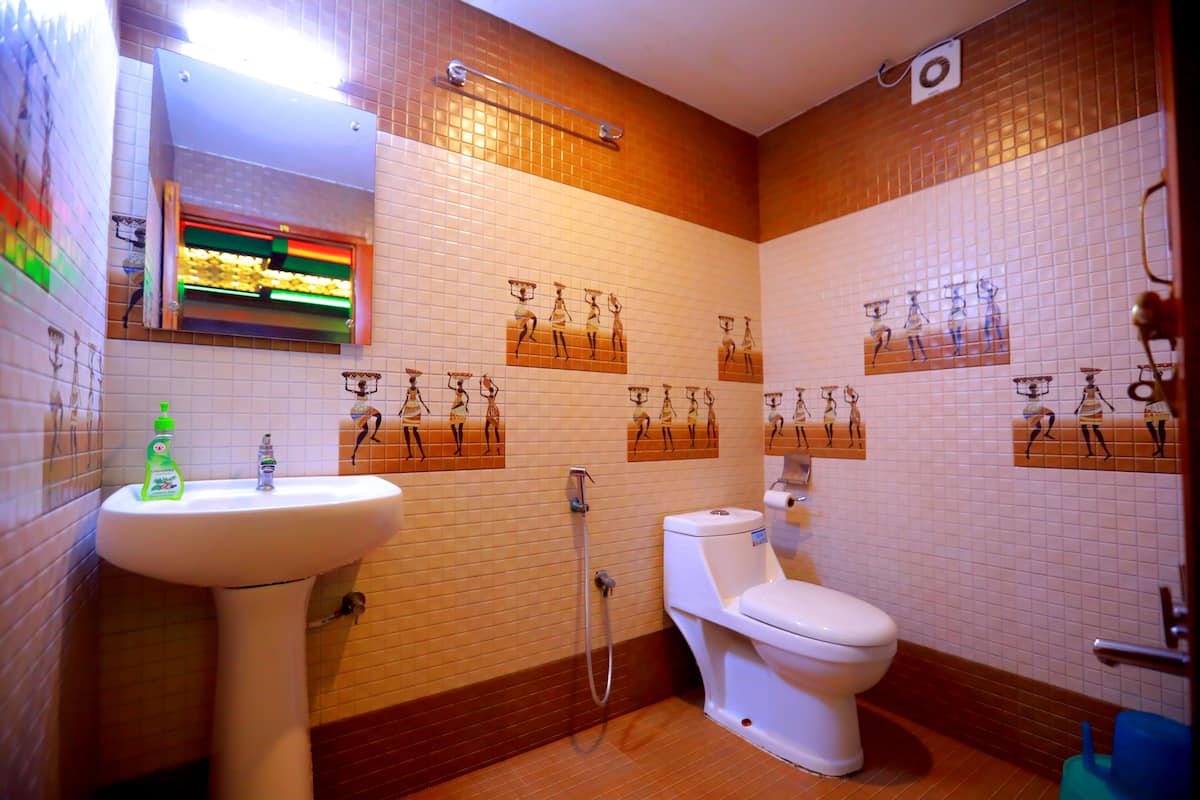 A bathroom with a sink, toilet, and shower.