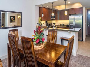 Enjoy meals in this kitchen with a dining table and six chairs, a large island, and pendant lighting.