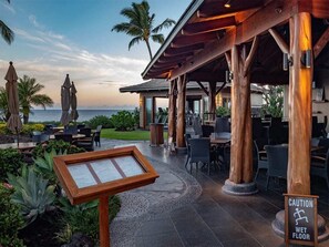 Relax in a serene outdoor space surrounded by lush greenery and ocean views.