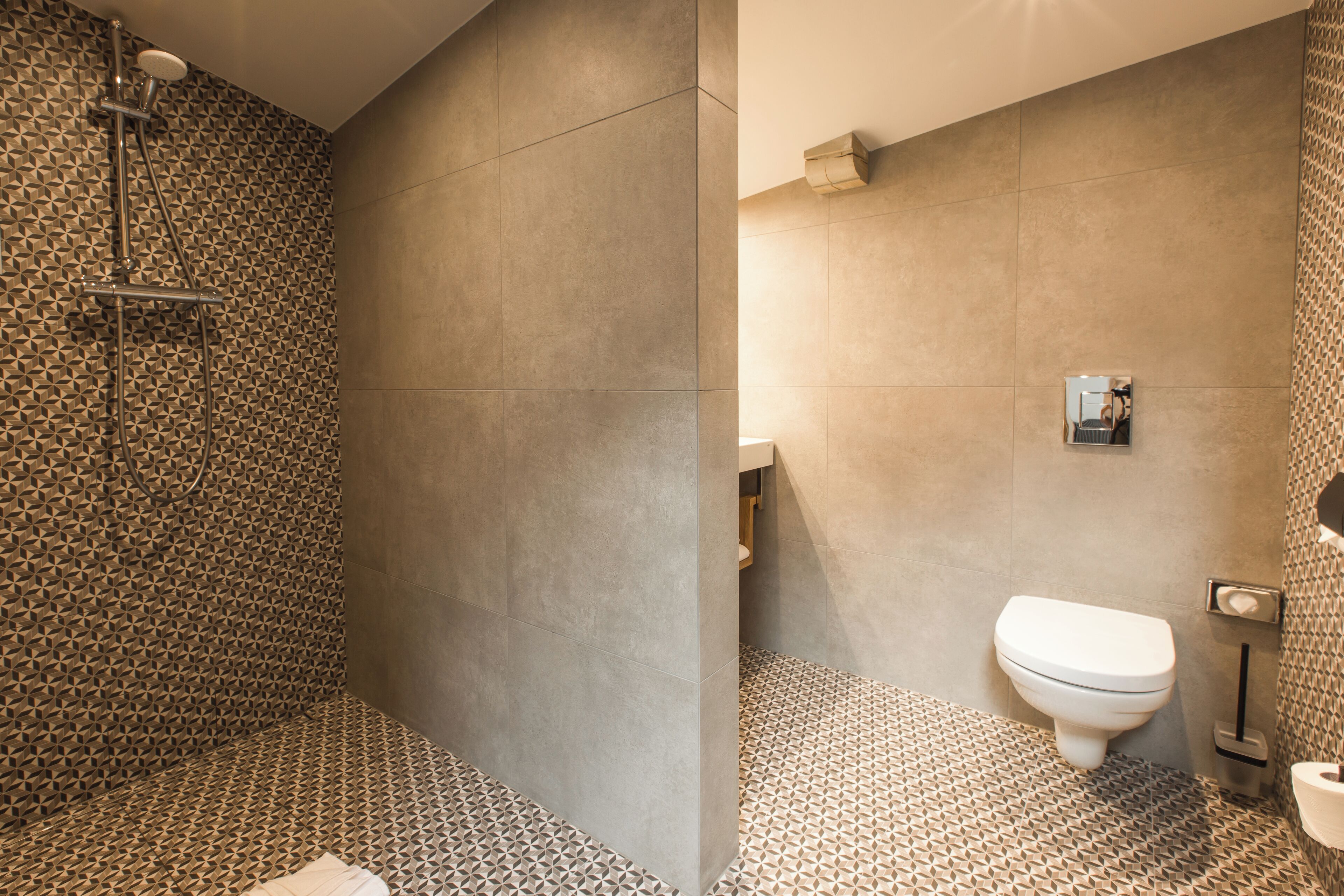 A bathroom with a shower, toilet, and sink.