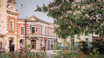 A historic building with classical architecture, including a clock tower and a facade with red and white stripes.