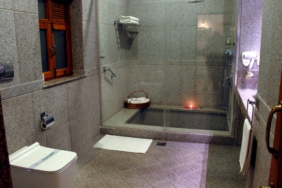 premium double room | bathroom | deep-soaking bathtub, rainfall showerhead, free toiletries, hair dryer