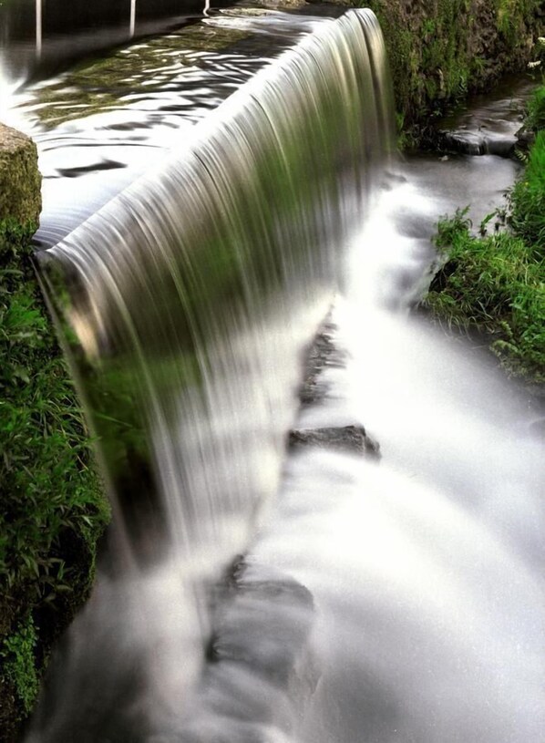 Ein Wasserfall stürzt über Felsen in einer natürlichen Umgebung.