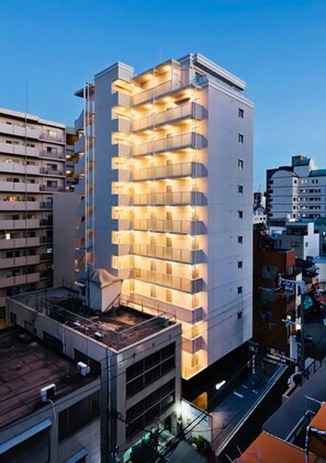 A multi-story building with a modern design, featuring balconies on each floor. - PG Kuromon (Osaka)