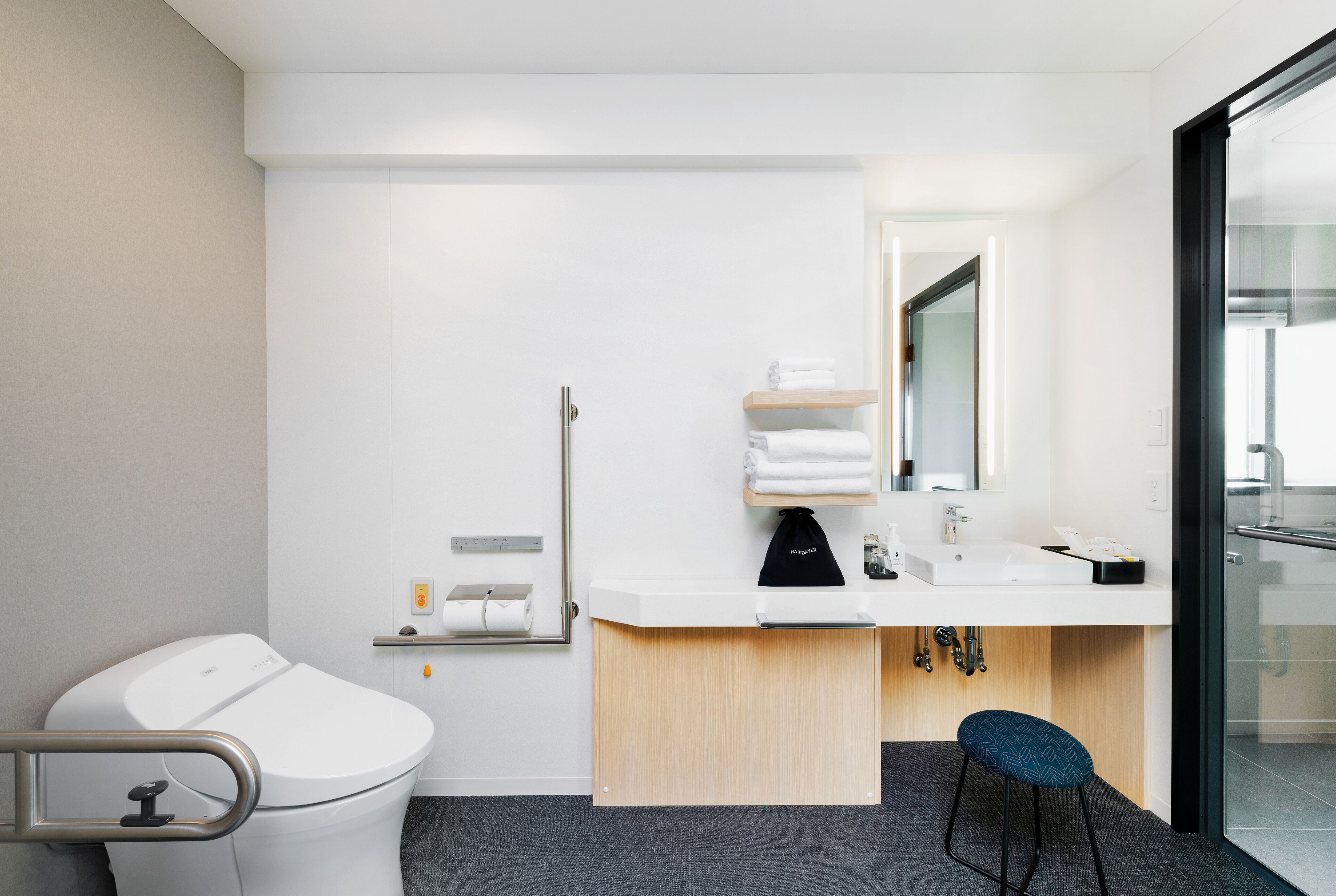 A modern bathroom with a toilet, sink, and shower area.