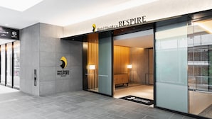 Hotel Hankyu RESPIRE entrance with a modern design, glass doors, and a visible reception area.