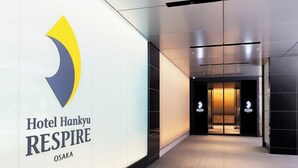 A hallway with a sign for Hotel Hankyu RESPIRE in Osaka.