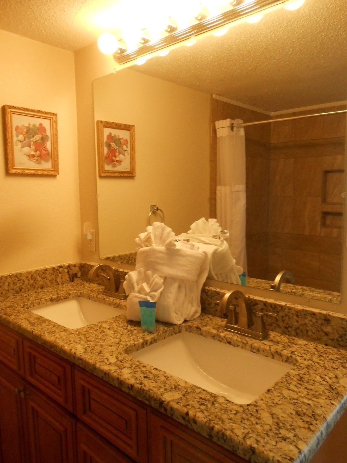 A bathroom with two sinks, a mirror, and towels.
