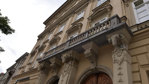 A classical building facade with ornate architectural details, including columns and decorative moldings. - Apartamenty w Pałacu Pod Baranami (Kraków)