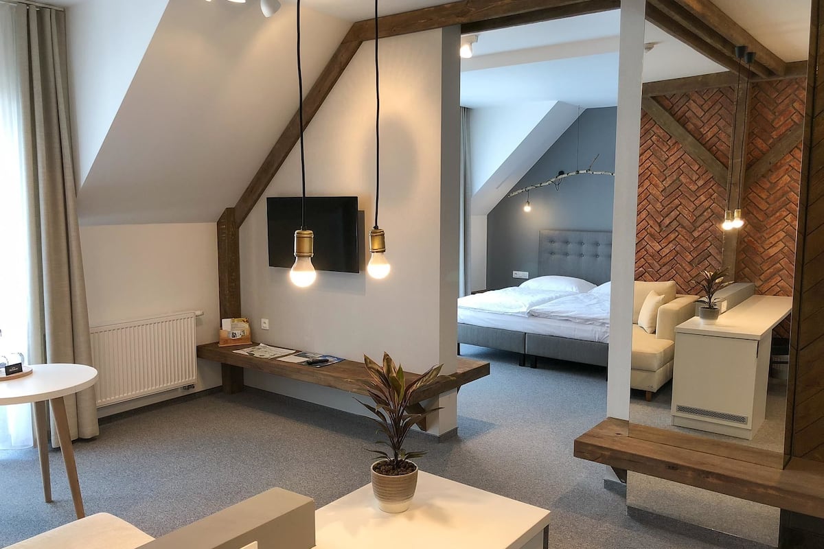 deluxe suite, 1 queen bed, lake view | in-room safe, desk, blackout curtains, rollaway beds