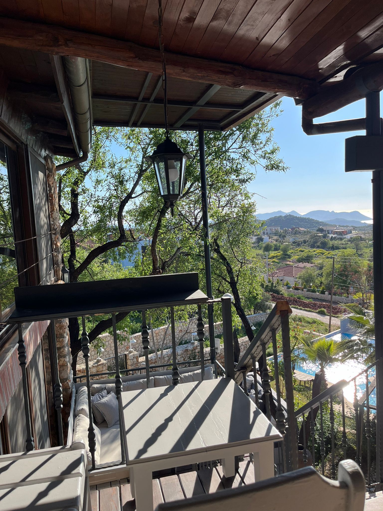 A wooden deck with a view of a mountainous landscape.