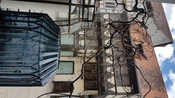 A building with a glass facade and a visible interior structure.