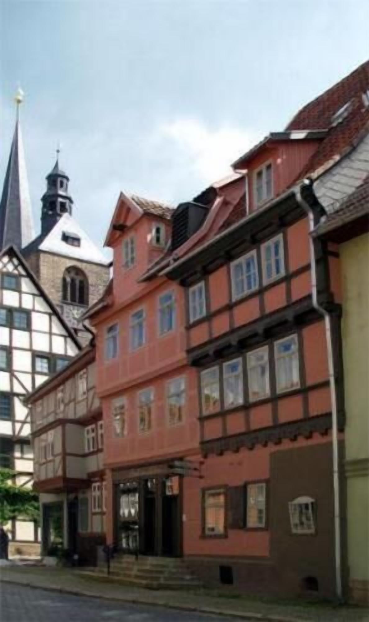 A traditional half-timbered building with a steeply pitched roof and a prominent tower.