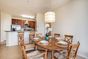 Dining in Style: Experience the epitome of elegance in our condo's dining area, adorned with sleek and sophisticated chairs for a luxurious dining experience