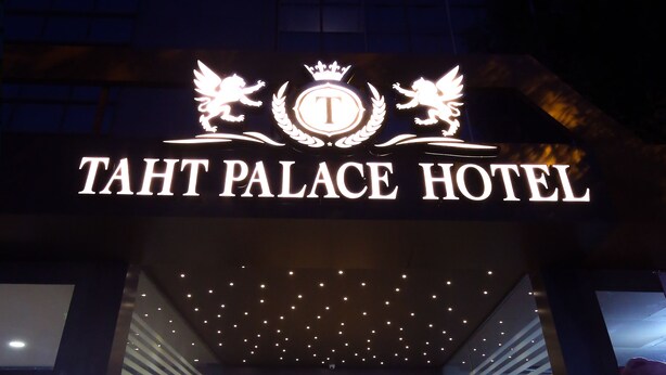 The entrance of TAHT PALACE HOTEL with a prominent sign and a well-lit pathway leading inside. - Taht Palace Hotel (Van)