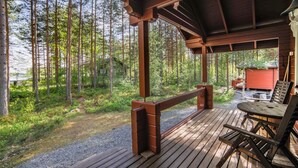 A wooden deck with a view of a forest.