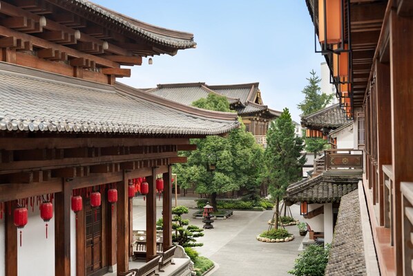 A traditional courtyard with wooden buildings, tiled roofs, and red lanterns. - Kempinski Hotel Hangzhou (Hangzhou)