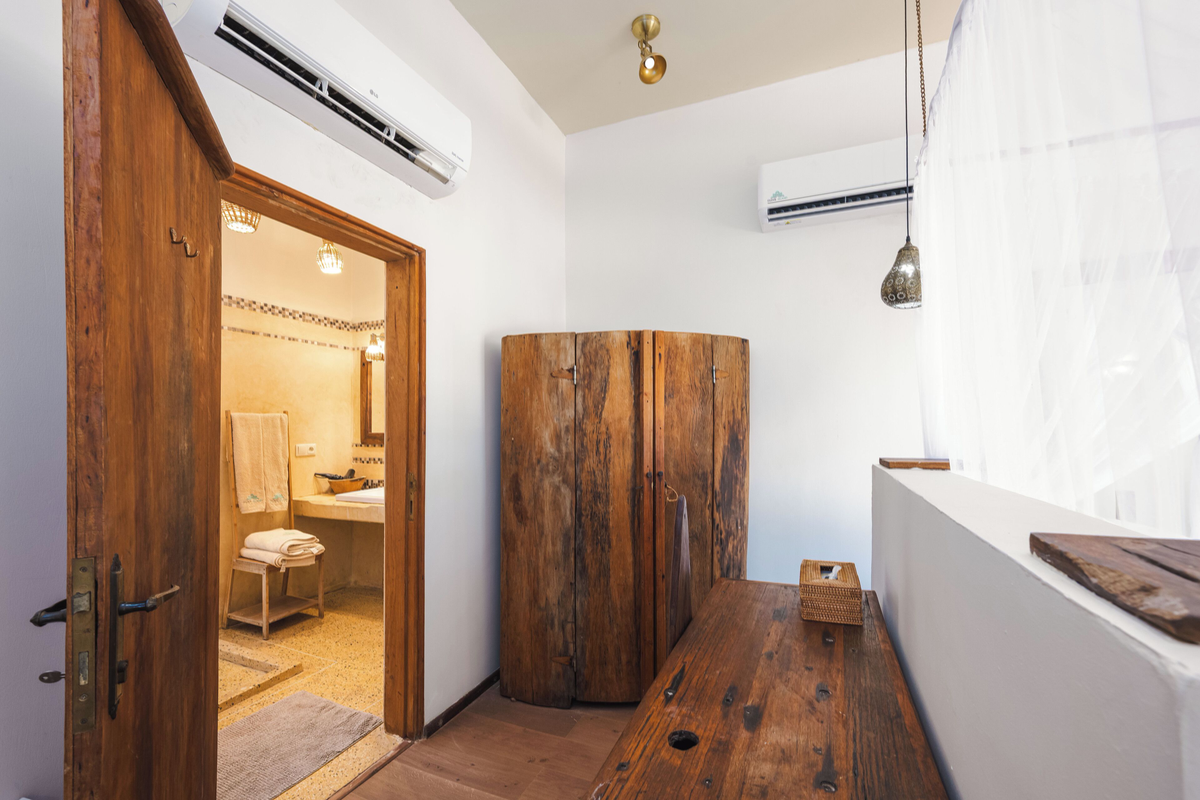 A bathroom with a wooden vanity, a sink, and a towel rack.