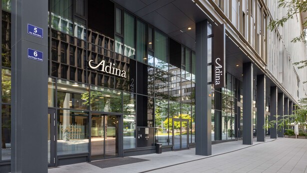 A modern building with large glass windows and the name 'Adina' prominently displayed. - Adina Serviced Apartments Vienna (Vienna)