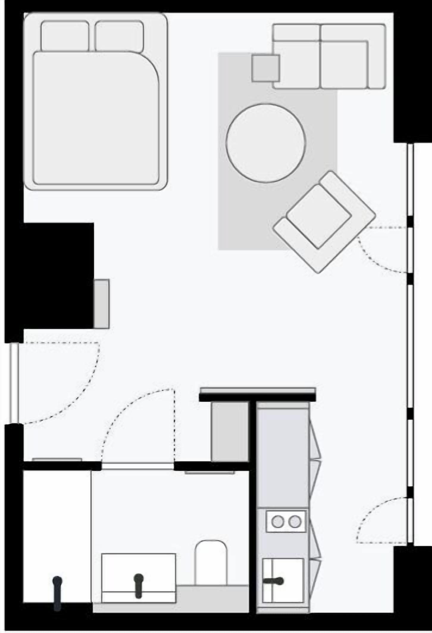 A floor plan of a hotel room with a bed, a desk, a chair, a small table, a sink, and a toilet.