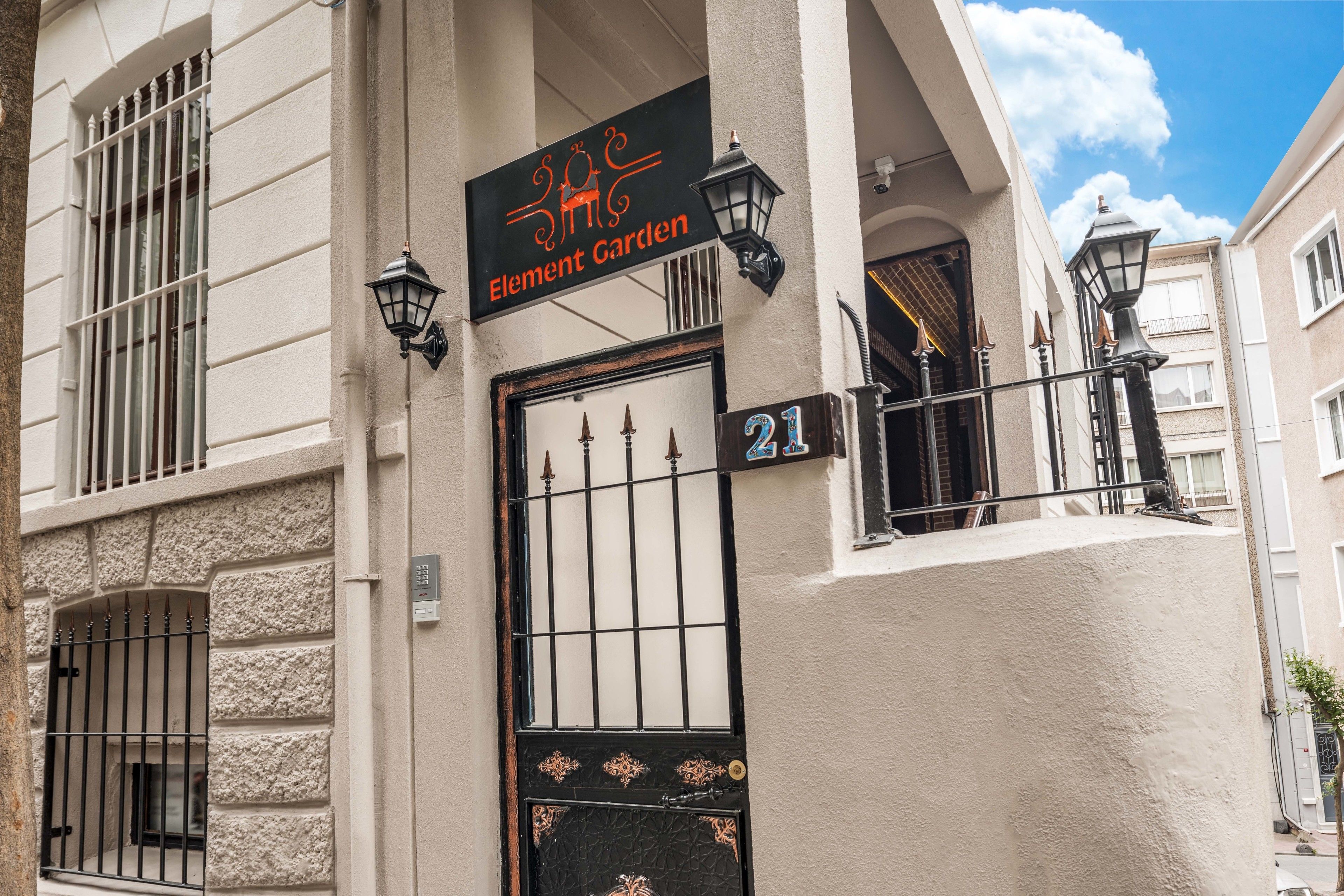 A building with a sign reading "Element Garden" and a number "21" on the door.