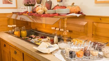 A buffet setup with various food items and beverages.