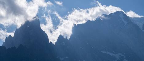 A mountain range with snow-capped peaks and a clear sky.