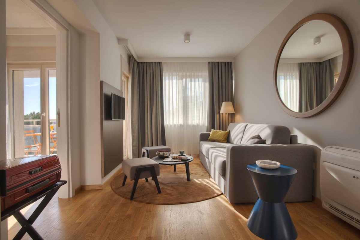 Deluxe Room, Partial Sea View | Living area | LED TV