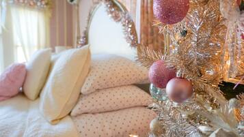 A neatly made bed with pillows and a decorative headboard.