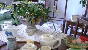 A breakfast table set with various breakfast items including bread, eggs, and fruit. - Beautiful country house with terrace and garden, ideally located (Cittanova)