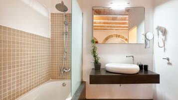 Une salle de bain moderne équipée d’une baignoire, d’une douche, d’un lavabo et d’un miroir.