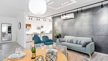 Family Apartment, 4 Bedrooms, City View | Living area | 28-inch flat-screen TV with cable channels, TV