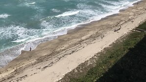 A beach with a clear view of the ocean and a sandy shoreline.