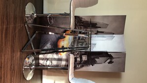 A modern, metallic, foldable table with a reflective surface and a cityscape photograph. - The Ultimate Vacation Spot! Modern at the same time! (Houston)