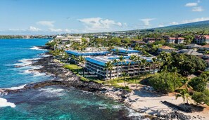 A coastal hotel with multiple floors, direct oceanfront access, and a beach nearby.