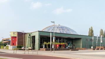 A building with a large glass dome, a green facade, and a sign indicating 'aqua park'.