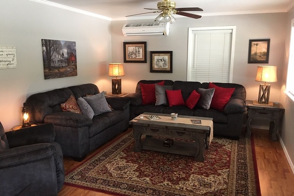 A cozy modern living room with comfy seating for up to five people.